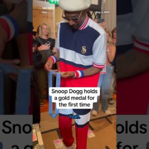 Snoop Dogg holds a gold medal for the first time